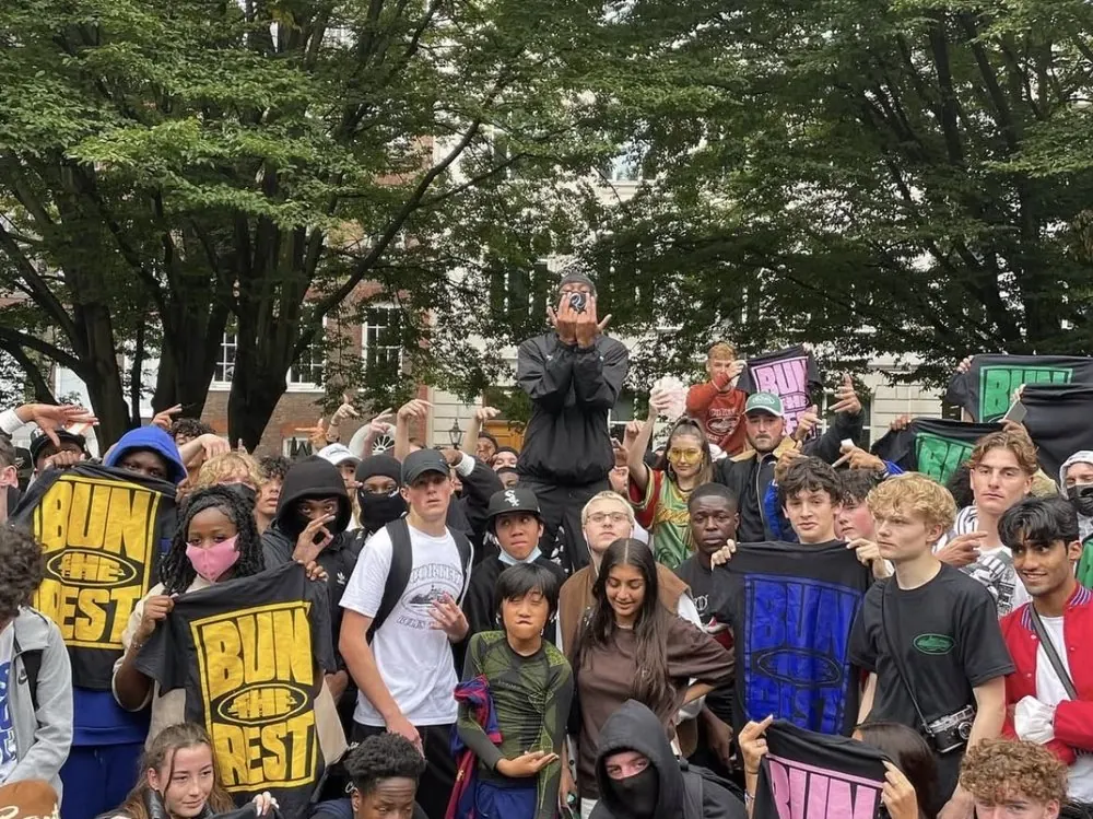 Group of young streetwear fans holding Bun the Rest t-shirts