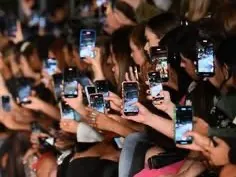 Fashion show audience filming on their phones